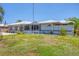 Well-maintained home with manicured lawn and flower pots at entrance at 619 Albee Farm N Rd, Nokomis, FL 34275
