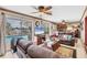 Spacious living room with ceiling fan, fireplace, sliding glass doors to the lanai and waterfront pool at 619 Albee Farm N Rd, Nokomis, FL 34275