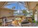 Enclosed patio with comfortable seating, providing an inviting outdoor space at 619 Albee Farm N Rd, Nokomis, FL 34275