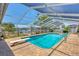 Sparkling pool featuring covered enclosure, diving board and waterfront views for outdoor enjoyment at 619 Albee Farm N Rd, Nokomis, FL 34275