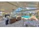 Enclosed patio with views of the screened pool, lakefront and outdoor seating perfect for entertaining at 619 Albee Farm N Rd, Nokomis, FL 34275
