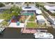 Rear exterior of home with dock, boat, and outdoor recreational features on a canal at 619 Albee Farm N Rd, Nokomis, FL 34275