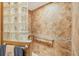 Shower featuring decorative glass block partition, grab bar and attractive brown tiled walls at 619 Albee Farm N Rd, Nokomis, FL 34275