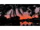 Scenic waterfront view at sunset with chairs silhouetted on the property's outdoor space at 619 Albee Farm N Rd, Nokomis, FL 34275