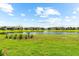 This backyard features a tranquil lake view and manicured landscaping at 6791 Alstead Cir, Bradenton, FL 34202