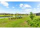 This lush backyard features a tranquil lake and well-maintained lawn at 6791 Alstead Cir, Bradenton, FL 34202