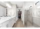 Modern bathroom with double vanity, glass shower, and access to a spacious walk-in closet at 6791 Alstead Cir, Bradenton, FL 34202
