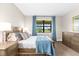 Tranquil bedroom with wood floors, a plush bed, and large windows offering scenic views at 6791 Alstead Cir, Bradenton, FL 34202