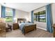 Inviting bedroom with wood floors, soft lighting, and large windows showcasing serene outdoor views at 6791 Alstead Cir, Bradenton, FL 34202