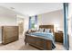 Comfortable bedroom featuring wood furniture, neutral walls, and bright natural light at 6791 Alstead Cir, Bradenton, FL 34202