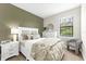 Cozy bedroom with accent wall, large window, and comfortable bed at 6791 Alstead Cir, Bradenton, FL 34202