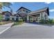 Community clubhouse featuring stone and siding facade, covered entrance, and professional landscaping at 6791 Alstead Cir, Bradenton, FL 34202
