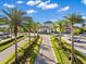 Community clubhouse features meticulously maintained landscaping and rows of palm trees leading to its entrance and parking at 6791 Alstead Cir, Bradenton, FL 34202