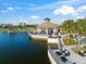 Beautiful clubhouse overlooking a lake with outdoor seating areas and a wooden dock with gazebo at 6791 Alstead Cir, Bradenton, FL 34202