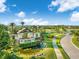 Del Webb Lakewood Ranch entrance with beautiful landscaping, water features, and palm trees under a sunny, blue sky at 6791 Alstead Cir, Bradenton, FL 34202