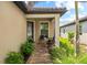 Charming home with brick pathway, covered entry, and lush landscaping at 6791 Alstead Cir, Bradenton, FL 34202