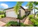 Charming home with a brick driveway, lush landscaping, and a manicured lawn at 6791 Alstead Cir, Bradenton, FL 34202