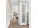 Hallway with hardwood floors leading to an open-concept living area with plenty of natural light at 6791 Alstead Cir, Bradenton, FL 34202