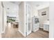 Hallway with hardwood floors leading to an open-concept kitchen and living area at 6791 Alstead Cir, Bradenton, FL 34202