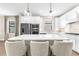 Bright kitchen featuring white cabinets, stainless steel appliances, and an island with seating at 6791 Alstead Cir, Bradenton, FL 34202
