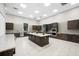 Spacious community kitchen with stainless steel appliances, dark wood cabinetry, and center island at 6791 Alstead Cir, Bradenton, FL 34202