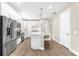 Bright kitchen with stainless steel appliances, white cabinets, and an island with seating at 6791 Alstead Cir, Bradenton, FL 34202