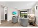 Bright living room with wood floors, modern decor, and sliding glass doors to outdoor patio at 6791 Alstead Cir, Bradenton, FL 34202