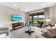 Spacious living room with a large television and access to the outdoors, perfect for Gathering time at 6791 Alstead Cir, Bradenton, FL 34202