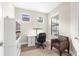 Bright office with a desk, shelves, and a comfortable chair by a window at 6791 Alstead Cir, Bradenton, FL 34202