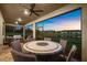 Screened patio with outdoor seating area and tranquil lake views at sunset at 6791 Alstead Cir, Bradenton, FL 34202