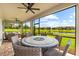 Screened patio featuring outdoor seating area with tranquil lake view at 6791 Alstead Cir, Bradenton, FL 34202