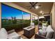 This screened patio offers a tranquil lake view and comfortable seating around a fire pit at 6791 Alstead Cir, Bradenton, FL 34202