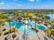 Stunning aerial view of a luxurious community pool surrounded by lush landscaping and palm trees at 6791 Alstead Cir, Bradenton, FL 34202