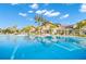 Inviting community pool in front of clubhouse and lounge seating, ideal for socializing and leisure at 6791 Alstead Cir, Bradenton, FL 34202
