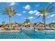 Stunning pool view with palm trees, beautiful landscaping and clubhouse, perfect for relaxation at 6791 Alstead Cir, Bradenton, FL 34202