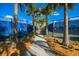 Paved walkway between two tennis courts in a neighborhood that is nicely landscaped with palm trees at 6791 Alstead Cir, Bradenton, FL 34202