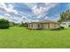 Lush backyard with a spacious lawn and well-maintained landscaping around the home's exterior at 6804 19Th W Ave, Bradenton, FL 34209
