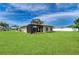 Spacious backyard with a screened-in lanai, well-kept lawn, and lush landscaping surrounding the home at 6804 19Th W Ave, Bradenton, FL 34209