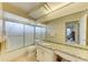 Bathroom featuring a vanity with granite counter, toilet, and shower/tub with patterned glass doors at 6804 19Th W Ave, Bradenton, FL 34209