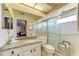 Accessible bathroom featuring a glass enclosed shower with safety bars and a granite vanity top at 6804 19Th W Ave, Bradenton, FL 34209