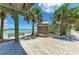 Scenic beach view with palm trees, turquoise water, and a charming boardwalk leading to a tranquil scene at 6804 19Th W Ave, Bradenton, FL 34209
