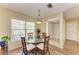 This well-lit dining area features wood floors, a glass table, and natural lighting from large windows at 6804 19Th W Ave, Bradenton, FL 34209