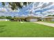 Single story home with a well-manicured lawn, concrete driveway, and a two-car garage on a sunny day with cumulus clouds at 6804 19Th W Ave, Bradenton, FL 34209
