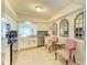 Bright kitchen features stainless steel appliances, granite counters, and two chairs with a small table at 6804 19Th W Ave, Bradenton, FL 34209