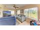 Sunroom living area with tile flooring, comfortable seating, and abundant natural light at 6804 19Th W Ave, Bradenton, FL 34209