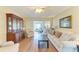 Spacious living room featuring wood floors, a display cabinet, and an adjoining dining area at 6804 19Th W Ave, Bradenton, FL 34209