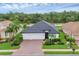 Overhead shot of a single-story home with a three-car garage and landscaped grounds in a quiet neighborhood at 7119 67Th E Ter, Bradenton, FL 34203