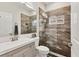 This bathroom showcases a large glass shower, vanity with sink, and decorative wall tiling at 7119 67Th E Ter, Bradenton, FL 34203