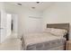 Bright bedroom featuring a neutral patterned bedspread, closet, and connecting hallway entrance at 7119 67Th E Ter, Bradenton, FL 34203