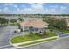Exterior aerial view of the community clubhouse with well manicured landscaping, lake, and ample parking at 7119 67Th E Ter, Bradenton, FL 34203
